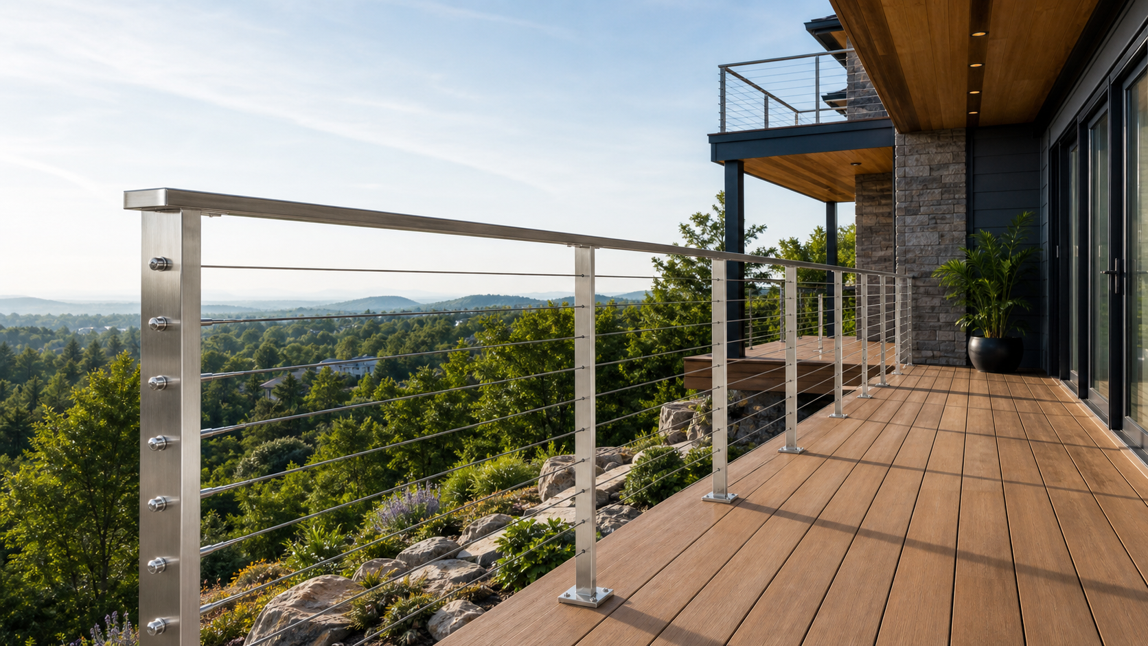Modern outdoor deck with stainless steel cable railing overlooking a landscape