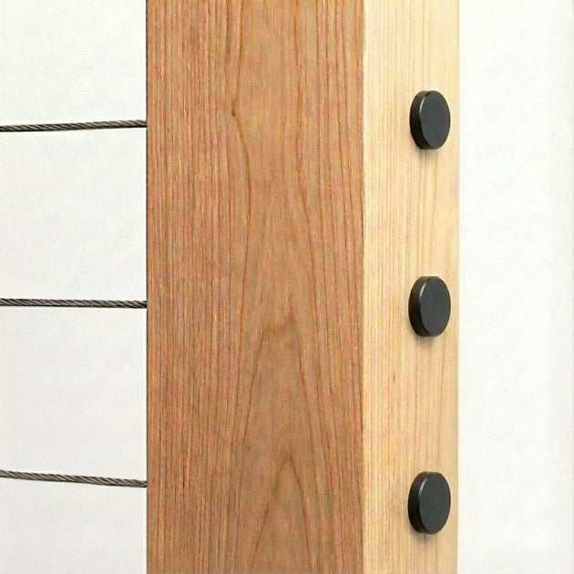 Exterior view of sleek black cable railing end caps sitting flush on a wood post