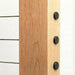 Exterior view of sleek black cable railing end caps sitting flush on a wood post