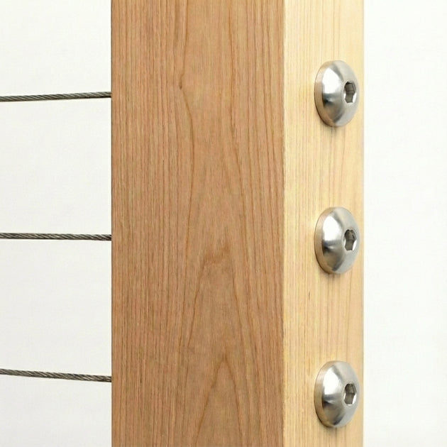 Decorative dome style round head cable railing hardware installed on wood post