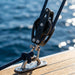 RiaYer marine pulley block in use on a yacht rigging system.