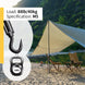 Action shot of a black stainless steel hook turnbuckle and carabiner being used to securely install a patio awning or sun shade sail outdoors.