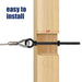 Close-up demonstrating a black heavy-duty eye bolt successfully passing through a thick wooden post, providing a secure anchor point for a tensioned steel cable.