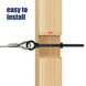 Close-up demonstrating a black heavy-duty eye bolt successfully passing through a thick wooden post, providing a secure anchor point for a tensioned steel cable.